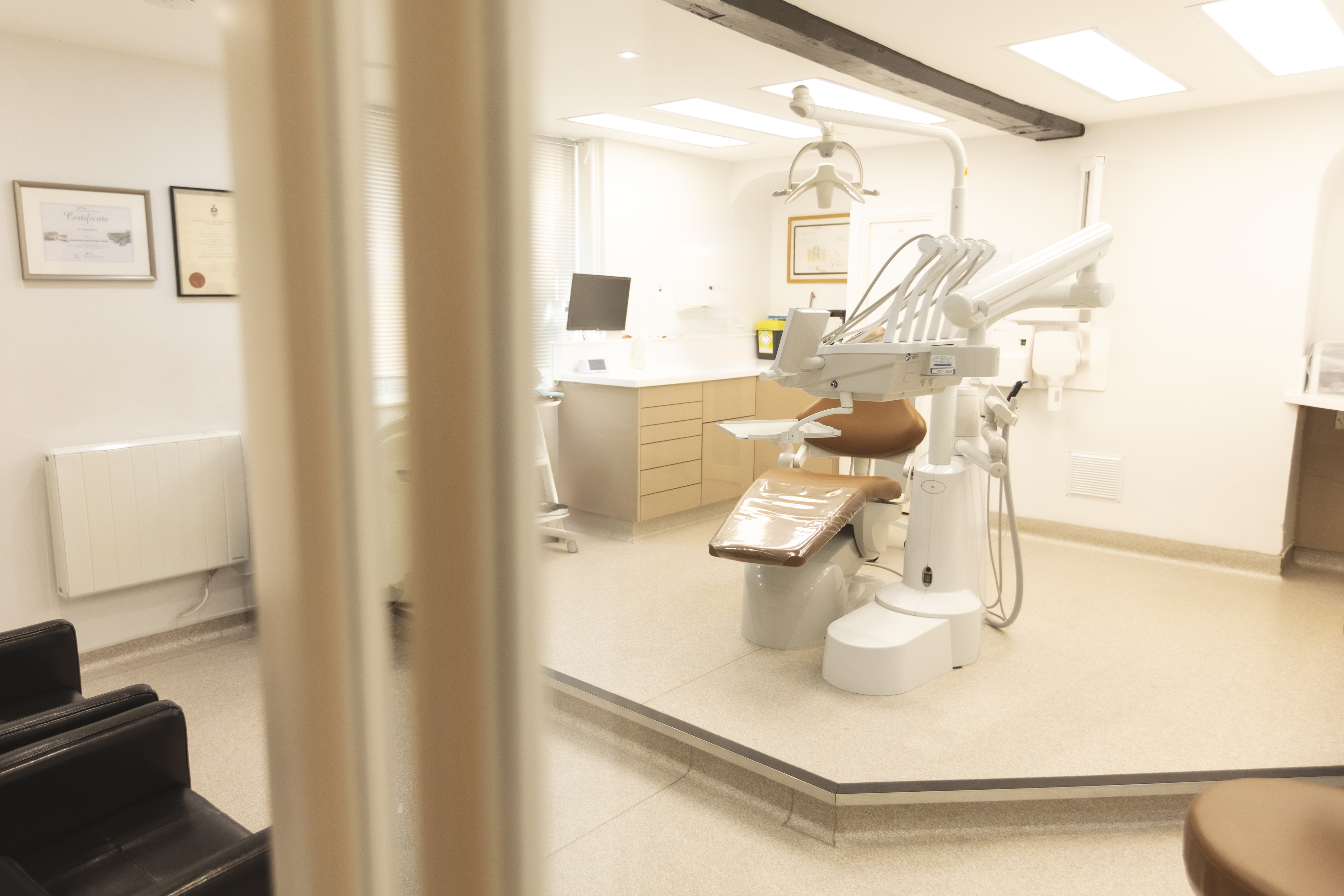 Dentist speaking with a patient in a modern treatment room